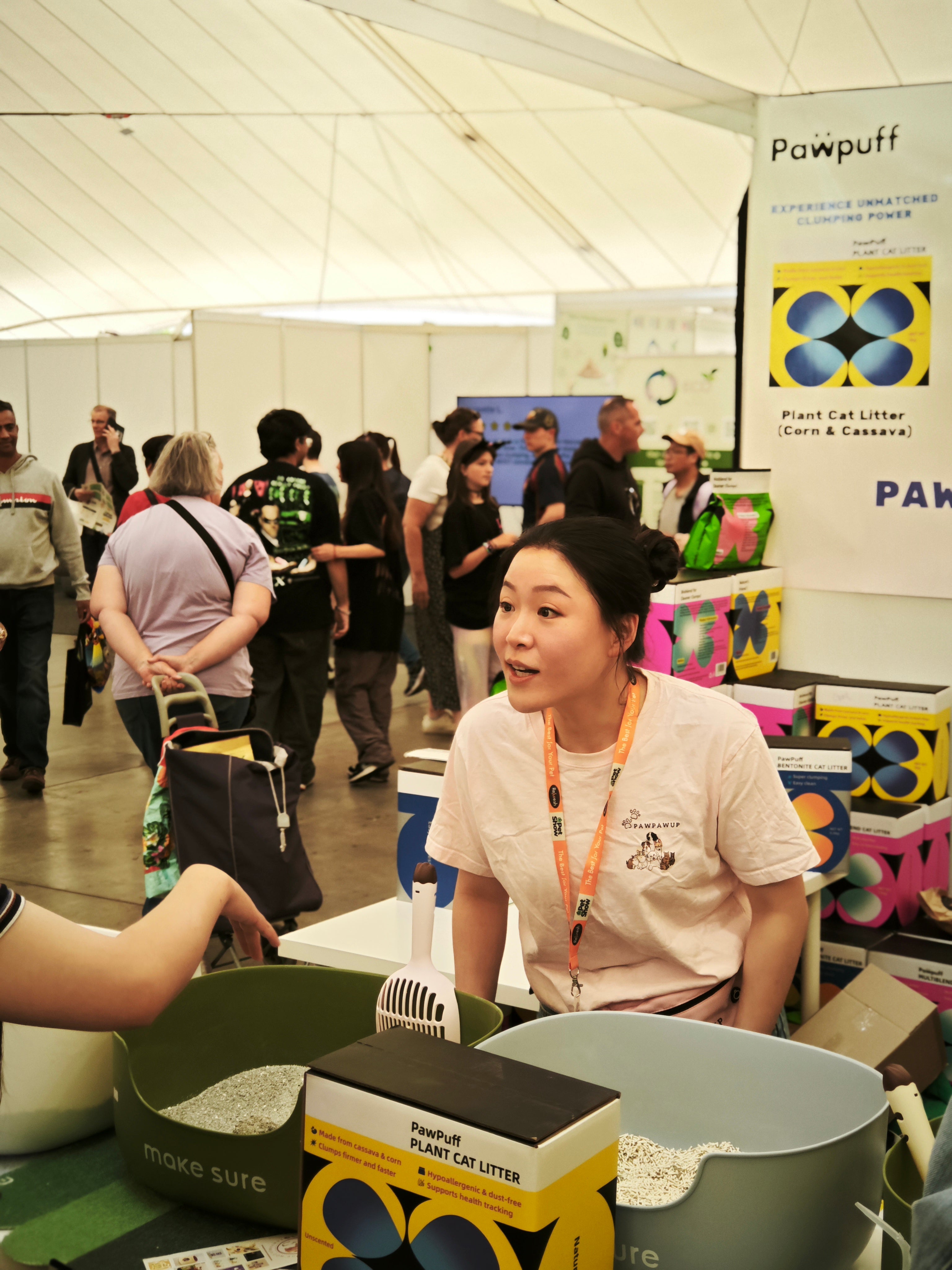 PawPuff booth at a pet supplies exhibition, presenting eco-friendly plant-based cat litter products from a leading pet store.